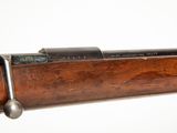 an old rifle with a wooden barrel and a metal handle