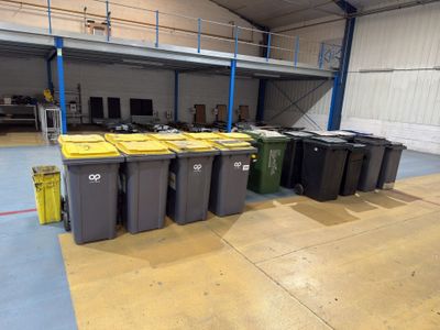 many bins of trash in a large warehouse