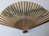 a fan hanging on the wall with a map on it