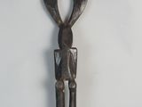 statue of a man holding a knife on a white surface