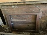 a wooden door that is open in the corner of a room