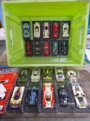 a lot of toy cars that are in a green box