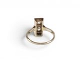 a close up of a gold ring with a diamond on it