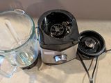 a blender sitting on a counter next to a glass of water