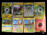 several pokemon cards sitting on top of each other on a table