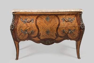 an antique chest of drawers with marble top