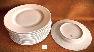 several white plates stacked on top of each other on a table