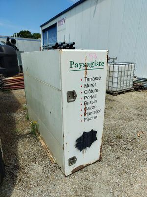 a refrigerator that is sitting outside of a building