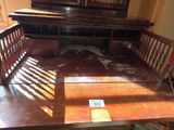 a wooden bench with a mirror on top of it