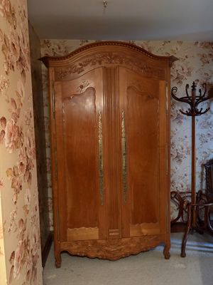 un grand meuble en bois dans le coin d'une pièce