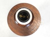 overhead view of a wooden vase with a black and white lid