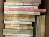 a box full of books sitting on top of each other