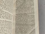 a book open on a table with a picture of a cat on it