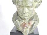 statue of a bust of a man with a bow tie on a black base