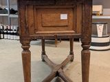 a small table with a drawer on it in the middle of a room