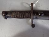 a close up of a knife hanging on a wall