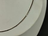 necklace on a white mannequin with a black background