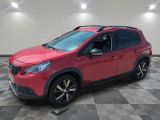 a red car parked in a room with a checkered floor