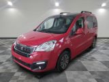 the red van is parked in a large room with a checkered floor