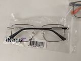 three pairs of glasses in plastic bags sitting on a table