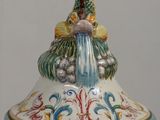 a ceramic container with a bird on top of it