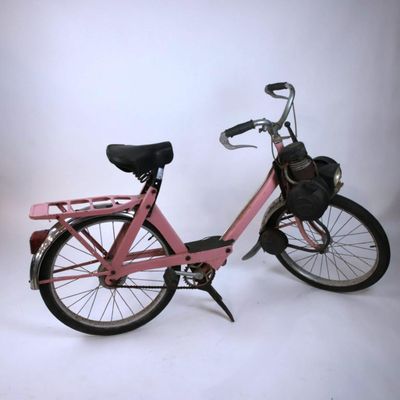 a pink bicycle with a basket on the back of it