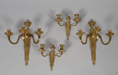 three brass wall sconces on a white background with a white background