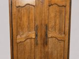an old wooden armoire with two doors on one side and a drawer on the other side
