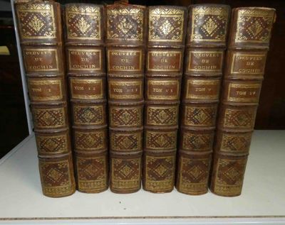 several old books are stacked on top of each other on a table