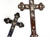 two crosses that are sitting next to each other on a table
