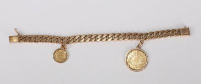 a close up of a gold bracelet with two coins on it