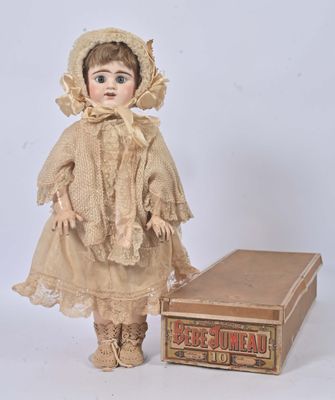 an old fashioned doll with a hat and dress next to a box
