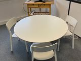 a white table and chairs in the corner of a room