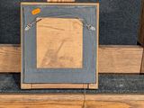 a picture of a wooden frame with a picture on it