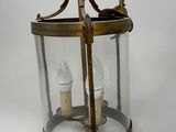 an old fashioned lantern with two candles inside of it on a white background