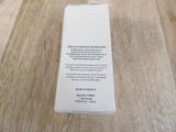 a white box on a wooden table with a label on it