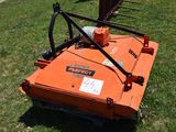 an orange lawn mower that is sitting in the grass