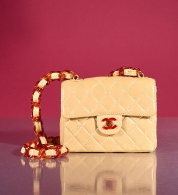 a small white purse with a chain around it