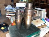 two vases sitting on top of a stack of books