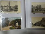 a person holding a book with pictures of buildings on it