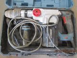 a drill in a case with a cord in it