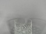 a close up of a glass on a table with a white background