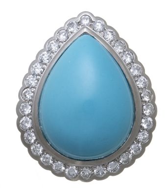 un gros plan d'un pendentif en turquoise et diamants