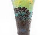 a glass vase with a painting of a tree on it