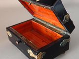 a small black box with a gold handle on a table
