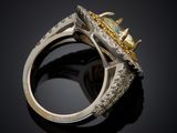 yellow sapphire and diamond ring on a black background