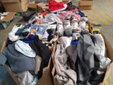 a cardboard box filled with clothes and other items