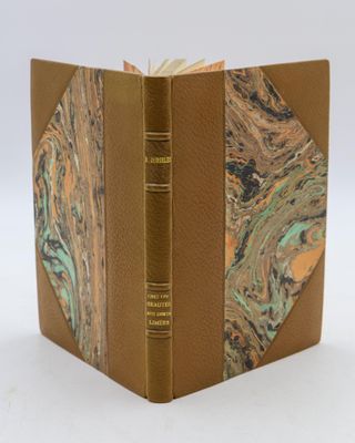 an open book with a marbled cover on a white surface