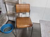a brown chair and a blue bowl on the floor