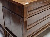 a wooden chest on a tile floor in a store